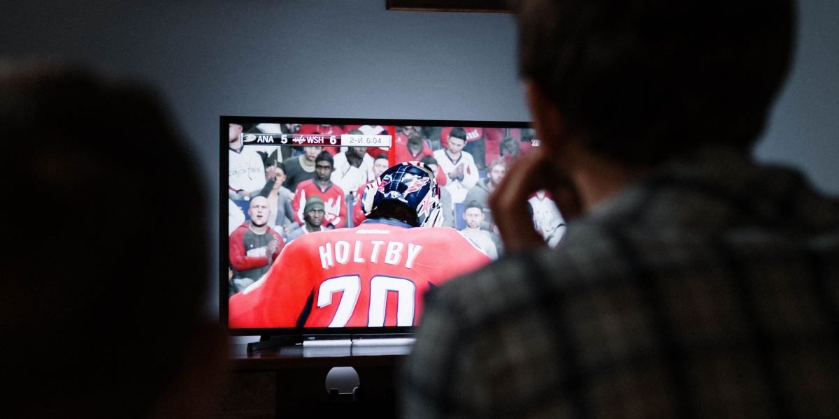 How the ESPN Wide World of Sports Complex Sets the Standard for Sports Broadcasting 4 Families engaging in interactive games and activities within a vibrant sports fan zone.