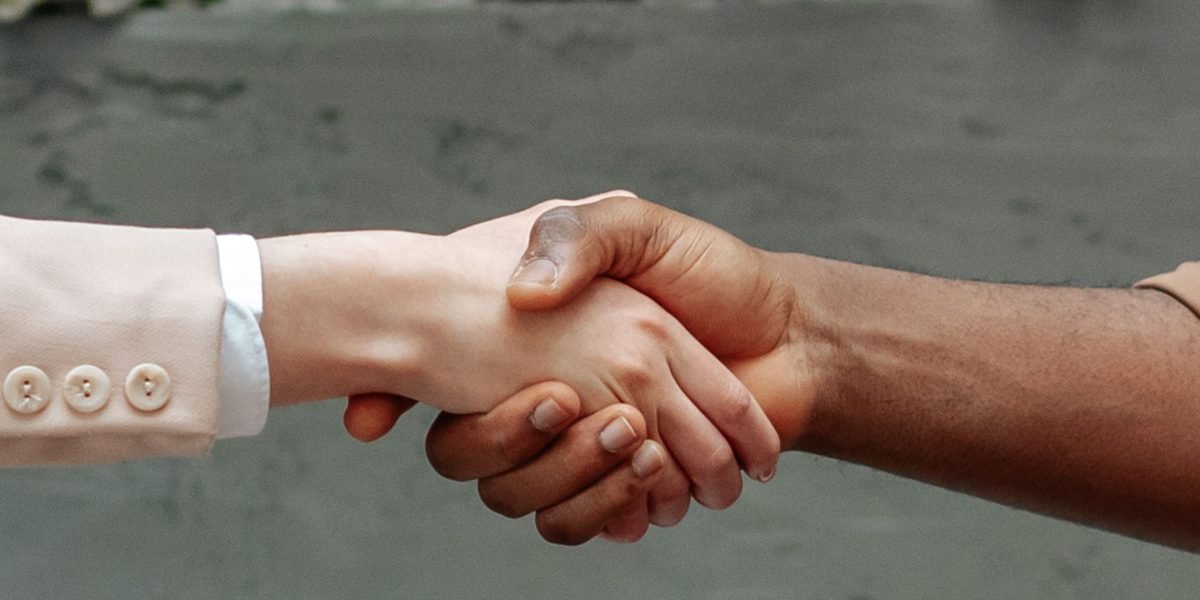 Simplify Your Live Sports Production with a Unified End to End Solution 7 Two professionals shaking hands, symbolizing a successful partnership that simplifies operations.