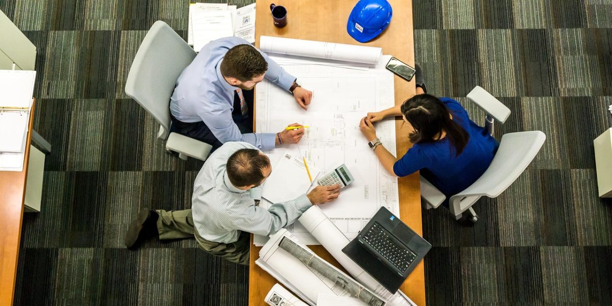 Professionals in a meeting discussing broadcast strategies and their alignment with business objectives.