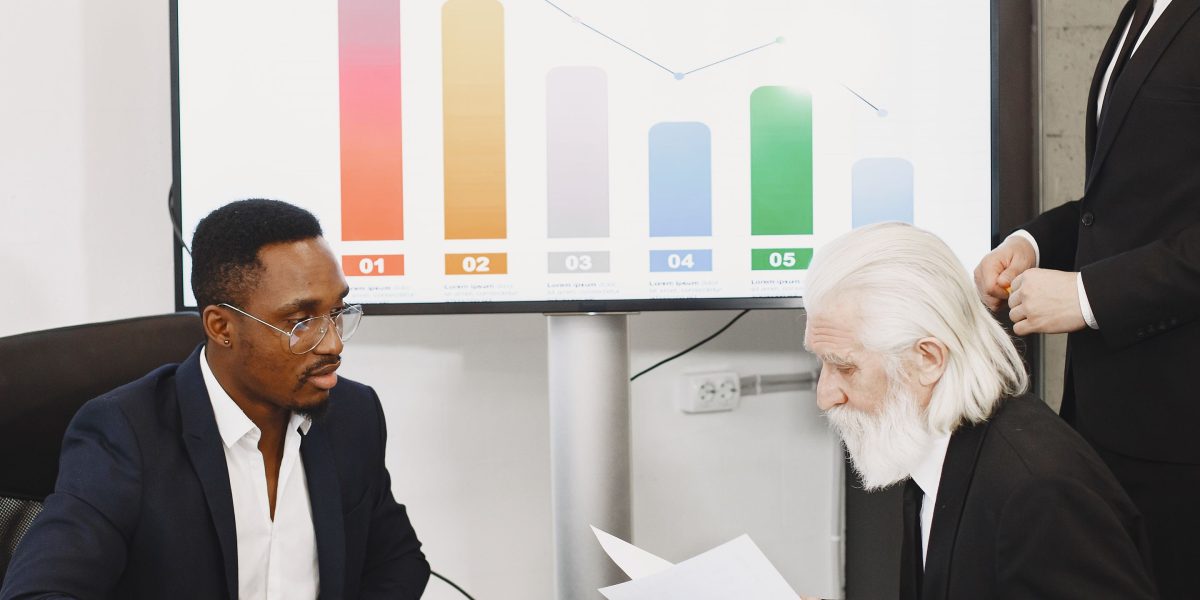 A business team in a meeting, discussing commercial planning aspects like ad insertion, sponsorships, and rights-holder obligations.