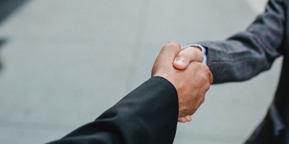 Professionals shaking hands, symbolizing a successful partnership agreement.